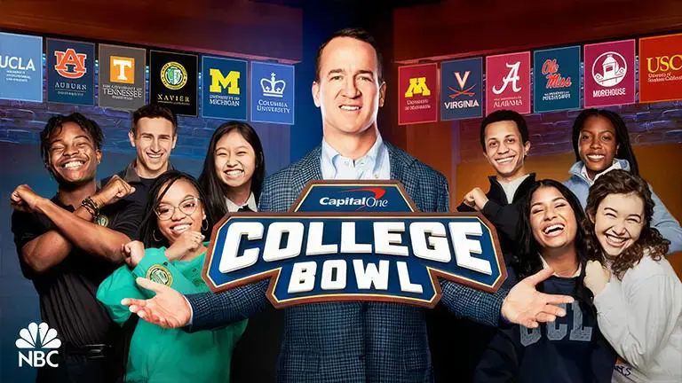 A group of people standing in front of a college bowl sign.